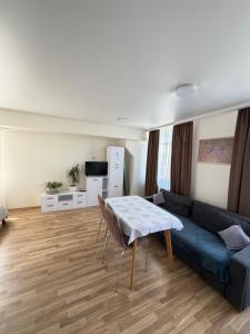 a living room with a blue couch and a table at Smart House Home in Kyiv