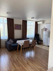 a living room with a couch and a table and chairs at Smart House Home in Kyiv