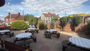 a group of tables and benches on a patio at White Horse Tavern in Telford
