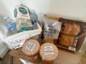 a table topped with three baskets of food and drinks at Trethvor House FREE PARKING, Ensuite Double Quiet residential area in Padstow
