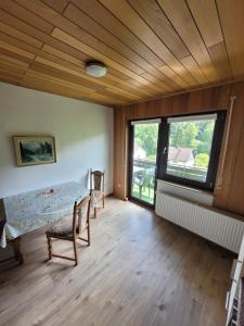 a room with a table and chairs and a window at Pension Schöne Aussicht in Witzenhausen