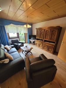 a living room with a couch and a table at Pension Schöne Aussicht in Witzenhausen