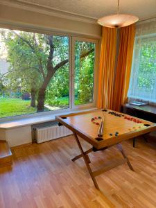 a pool table in a room with a large window at Lake&Forest&City in Riga