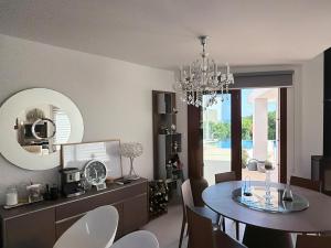 a dining room with a table and a chandelier at The Sea Breeze in Paralimni