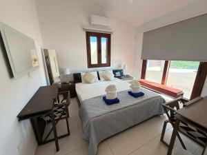 a bedroom with a bed and a table and a desk at The Sea Breeze in Paralimni +67 photos