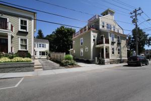 a house on a street with a car parked in front at The Newport Lofts - 548 Thames Street in Newport