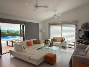 a living room with two couches and a tv at The Sea Breeze in Paralimni