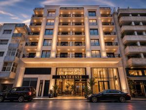 two cars parked in front of a large building at L'ADRESSE Boutique Hôtel & SPA Tanger in Tangier