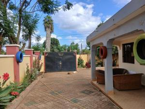 a patio with a large black screen in a yard at Friendly hostel in Arusha