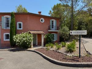 a house with a street sign in front of it at Villa Les Mimosas, Fayence in Fayence