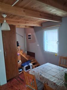 a room with a bed and a table and a window at Domek Letniskowy Ewa in Turawa