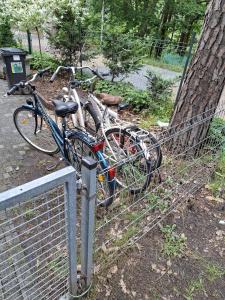 a couple of bikes parked next to a fence at Domek Letniskowy Ewa in Turawa