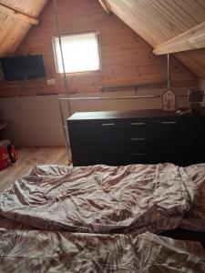 a bedroom with a large bed in a attic at Domek Letniskowy Ewa in Turawa