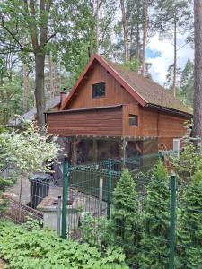 a barn with a fence in front of it at Domek Letniskowy Ewa in Turawa