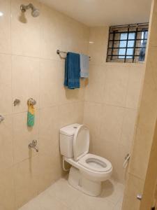 a bathroom with a toilet and a shower with blue towels at One Private Room Near Dhaka Airport in Dhaka +12 photos