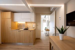 a kitchen with wooden cabinets and a table in a room at Casa Bellariva in Cattolica