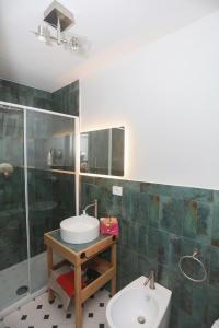 a bathroom with a sink and a shower at Casa Elisabetta in Tuscania