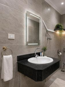 a bathroom with a sink and a mirror at Aziz Egypt Hotel in Cairo