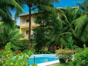 a resort with a swimming pool in front of a building at Muthukirula Resort in Aluthgama