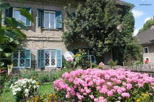 a garden with pink flowers in front of a house at Gasthaus Kopper in Guttaring