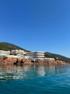a group of buildings on the shore of the water at Studio calme vue mer pieds dans l'eau in Saint-Raphaël +8 photos