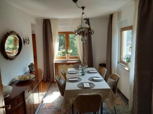 a dining room with a white table and chairs at Eifel Waldhaus in Simmerath