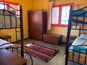 a room with two bunk beds and a table and a window at Al Obayed Garden Villa in Marsa Matruh +15 photos