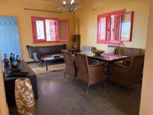 a living room with a dining room table and chairs at Al Obayed Garden Villa in Marsa Matruh