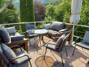 a balcony with chairs and a table with a view at Eifel Waldhaus in Simmerath