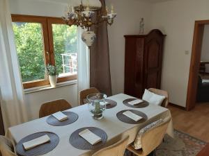 a dining room table with a white table cloth and chairs at Eifel Waldhaus in Simmerath +22 photos