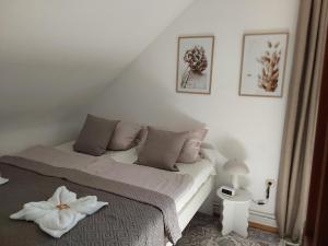 a bedroom with a bed with a white flower on it at Eifel Waldhaus in Simmerath