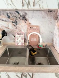 a kitchen sink with a faucet next to a counter at Vefxos Guest home in Anaklia +24 photos