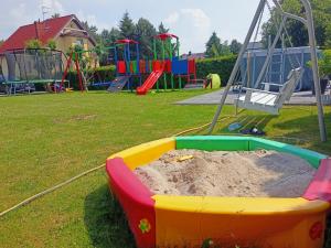 a sandbox in a park with a sand pit at Domki Platinium Sianożęty Ustronie Morskie in Sianozety
