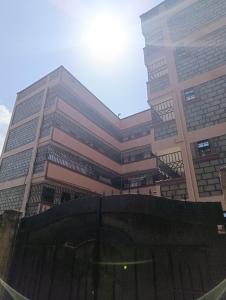 a tall building with a fence in front of it at BR Homes 2 Bedroom in Bungoma