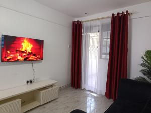 a living room with a fire on the wall at BR Homes 2 Bedroom in Bungoma