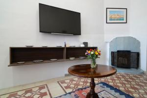 a living room with a table and a flat screen tv at 458 - Favlyn Boutique Apartments in Sliema