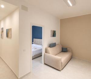 ein Wohnzimmer mit einem Sessel und einem Bett in der Unterkunft Etnera in Trecastagni