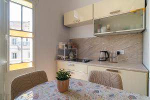 a kitchen with a table and chairs and a counter at 458 - Favlyn Boutique Apartments in Sliema