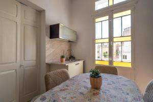a dining room with a table and a kitchen at 458 - Favlyn Boutique Apartments in Sliema
