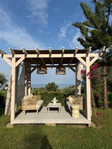 a wooden gazebo with couches and a table at Villa BellaVista in Belvedere Marittimo