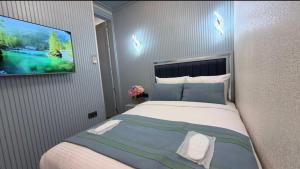 a bedroom with a large bed with a tv on the wall at Santa Rio Taxim in Istanbul