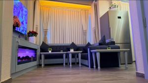 a room with two tables and a couch and a tv at Santa Rio Taxim in Istanbul