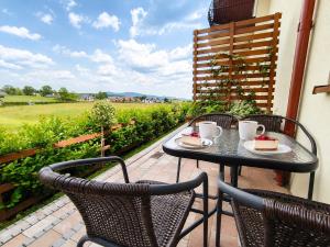 a patio with a table with two cakes on it at Willa Panorama 881-751-206 in Polańczyk