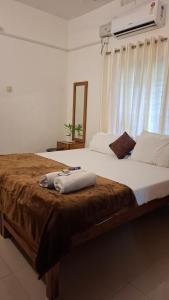 a bedroom with a large bed with a window at Purayilhomestay in Varkala +55 photos