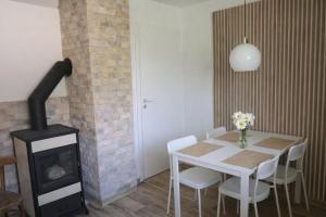 a dining room with a table and a wood stove at Ponte Liptov in Liptovský Trnovec