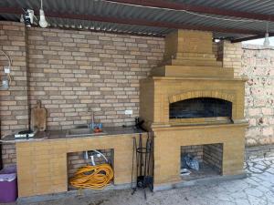 a brick oven with a sink and a hose at Blue Garden in Nor Hachyn