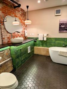 a bathroom with a toilet and a sink and a tub at Gamble Mill in Bellefonte +35 photos