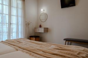 a bedroom with a bed with a large window at Domus Alta in Tsilivi