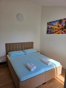 a bedroom with a bed with two towels on it at ANTODO Batista in Novalja +92 photos