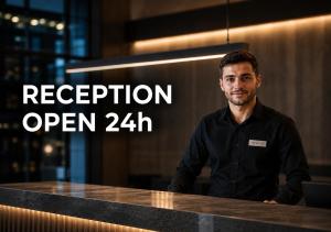 a man standing in front of a counter with the words reception open at Hotel Cezar Banja Luka in Banja Luka